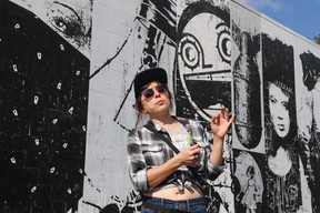 Tour guide Miss Crit passionately explains street art in front of a Bask mural in downtown St. Petersburg. Veronica Henri photo