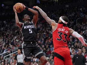 Kings guard De'Aaron Fox (left) drives to the basket as Raptors guard Gary Trent Jr. (right) tries to defend during second quarter NBA action at Scotiabank Arena in Toronto, Wednesday, Dec 14, 2022.