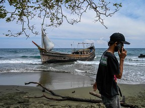 This picture shows a boat that was carrying Rohingya refugees after their arrival at a beach in Krueng Raya, Indonesia's Aceh province on December 25, 2022.