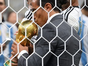 Nusret Goekce, nicknamed Salt Bae, kisses the FIFA World Cup Qatar 2022 Winner's Trophy after the FIFA World Cup Qatar 2022 Final match between Argentina and France at Lusail Stadium on December 18, 2022 in Lusail City, Qatar.