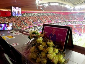 Flowers are laid at a media tribune desk in memory of American journalist Grant Wahl on Dec. 10, 2022 at Al Bayt Stadium in Al Khor, Qatar, ahead of the FIFA World Cup quarter-final match between England and France.