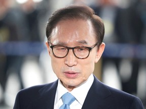 South Korea's former president Lee Myung-bak arrives at the prosecutors' office in Seoul, South Korea, March 14, 2018.