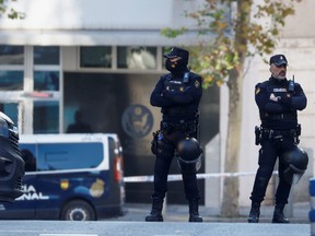 Police officers stand outside the U.S. Embassy in Madrid after a suspected explosive device hidden in an envelope was mailed to the embassy, in the wake of other packages sent to targets connected to Spanish support of Ukraine, amidst Russia’s invasion of Ukraine, in Madrid, Spain Dec. 1, 2022.
