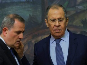 Russia's Foreign Minister Sergei Lavrov, right, and Azerbaijan's Foreign Minister Jeyhun Bayramov, left, attend a news conference, in Moscow, Dec. 23, 2022.