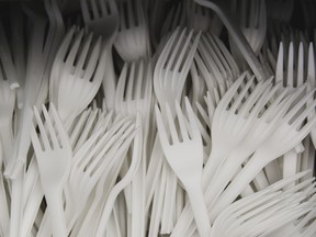 High angle view of a drawer of disposable plastic forks.