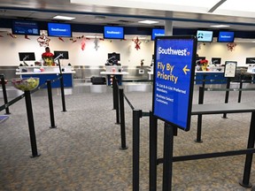The Southwest Airlines check-in counter is seen mostly empty at Hollywood Burbank Airport in Burbank, Calif., Tuesday, Dec. 27, 2022, after bad weather led the company to cancel flights.