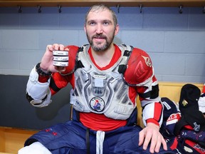 Alex Ovechkin of the Washington Capitals poses with the pucks from his 798th, 799th and 800th career goals after the game at United Center on Dec. 13, 2022 in Chicago, Illinois.