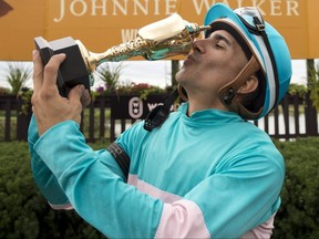 Jockey Rafael Hernandez celebrates after riding Moira to victory in the 163rd running of the Queen's Plate Stakes on Aug. 21, 2022, at  Woodbine. Hernandez suffered a season-ending rib injury on Dec. 9, 2022.
