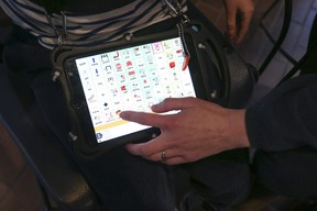 Karolina Krystyniak and her son Franek, 8, who has Angelman syndrome and is seen here using his conversation tablet to speak on Tuesday November 29, 2022.