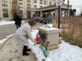 Marilyn Iafrate, a Vaughan city councillor, dropped off five bouquets of flowers to the memorial for the five people shot to death at a Jane St. and Rutherford Rd. condo Sunday night. SCOTT LAURIE/TORONTO SUN