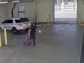 In this image taken from video released by the Tampa Police Department, police officer Gregory Damon drags a woman across the floor at Orient Road Jail in Tampa, Fla., Nov. 17, 2022.