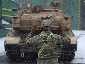 A U.S. soldier from U.S. 2nd Armored Brigade Combat Team (ABCT) directs military equipment which arrived in the Polish port of Gdynia as part of NATO's Operation Atlantic Resolve in Gdynia, Poland December 3, 2022.