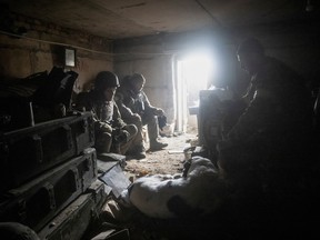 Ukrainian service members rest in their shelter in Bakhmut, in Donetsk region, Ukraine, December 9, 2022.