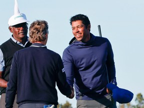 Bernhard Langer (middle) congratulates Vijay Singh (left) and son Qass Singh on winning the PNC Championship at the Ritz Carlton Golf Club Grande Lakes Orlando Course on Sunday.