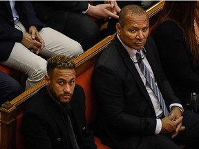 (FILES) In this file photo taken on October 17, 2022 Paris Saint-Germain's Brazilian forward Neymar (L) and his father Brazilian former footballer Neymar Senior look on during the opening audience at the courthouse in Barcelona, on the first day of their trial. - A Barcelona court on December 13, 2022, acquitted Brazilian football star Neymar and all of his co-defendants in the trial over alleged irregularities during his transfer to FC Barcelona in 2013. The judges decided to "release the nine accused", ruling that they had not found an offence had been committed, said a court press release after a trial marked by the surprise withdrawal of the prosecution charges. (Photo by Josep LAGO / AFP)