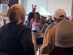 A woman screams at American Airlines staff Tuesday at Miami International Airport.
