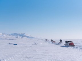 A convoy of support snowmobiles with qamutiks in tow, head toward the first Nunavut Quest camp, roughly 50km outside of Arctic Bay, Nunavut on Monday, April 18, 2022. A new report details how widespread changes in the Arctic, from warming air temperatures to sea-ice loss, have affected animals, plants and people living there.