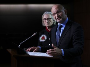 Minister of Justice and Attorney General of Canada David Lametti and Carolyn Bennett, Minister of Mental Health and Addictions and Associate Minister of Health, hold a press conference on Parliament Hill in Ottawa, Thursday, Dec. 15, 2022.
