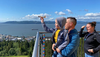 Jordan Timmerman, 6, of Honolulu, launches a glider from atop the Astoria Column with parents Josh and Peggy. (Alex Pulaski for The Washington Post)