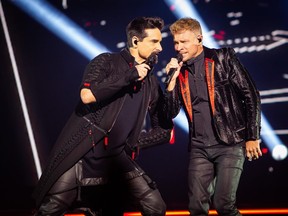 Kevin Richardson and Brian Littrell are pictured onstage during Backstreet Boys' DNA World Tour in 2019.