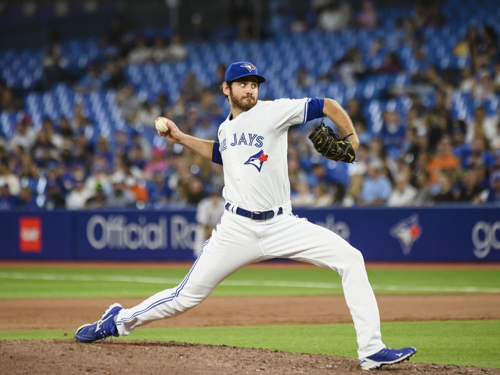 April 11, 2023, TORONTO, ON, CANADA: Toronto Blue Jays relief pitcher  Jordan Romano (68) celebrates with the Tip O'Neill Award as top Canadian  baseball player for 2022 prior to MLB American League