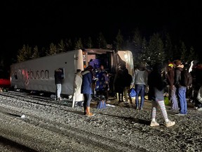 First responders and passengers look over the scene of a fatal bus crash on Highway 97C Okanagan Connector between Merritt and Kelowna in this Saturday, Dec. 24, 2022