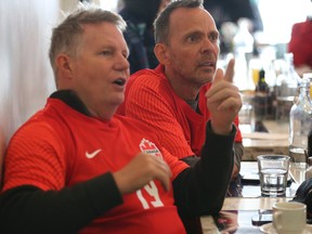 Canada soccer fans Bob Boettchner, left, and John Mozas watch the match between Canada and Morocco at Cafe Diplimatico on College St. on Thursday, Dec. 1, 2022.