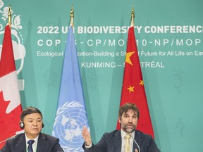 Steven Guilbeault, Minister of Environment and Climate Change, Canada, right, speaks during the opening news conference of COP15, the UN Biodiversity Conference, in Montreal, Tuesday, December 6, 2022, as Huang Runqiu, President, COP15 and Minister of Ecology and Environment of China looks on.