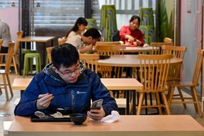 Diners eat in a restaurant in Guangzhou city’s Tianhe district in China’s southern Guangdong province on Dec. 1, 2022, following the easing of COVID-19 restrictions in the city.