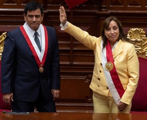 President of the Peruvian Congress Jose Williams Zapata (left) stands next to Dina Boluarte (right) after swearing her in as the new President hours after former President Pedro Castillo was impeached in Lima, on Dec. 7, 2022.