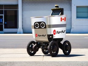 An autonomous robot delivering a pizza from Pizza Hut is shown in Vancouver in this undated handout photo.