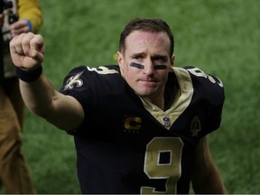 New Orleans Saints quarterback Drew Brees waves to the crowd as he walks off the field after an NFC Divisional Round playoff game against the Tampa Bay Buccaneers at Mercedes-Benz Superdome.