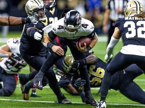 Atlanta Falcons quarterback Desmond Ridder rushes against New Orleans Saints safety Tyrann Mathieu  during the second half at Caesars Superdome.