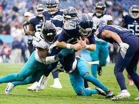 Tennessee Titans quarterback Ryan Tannehill is tackled by by Jacksonville Jaguars linebacker Foyesade Oluokun  during the fourth quarter at Nissan Stadium.