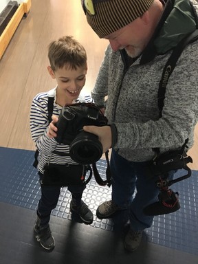 Franek Krystyniak, 8, who has Angelman syndrome, loves technology and is seen here checking out Toronto Sun photographer Jack Boland’s camera on Tuesday, Nov. 29, 2022.