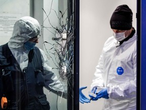 A bullet hole is seen in a window pane as forensic police officers examine the premises of a private radio station in the so-called Ammonhof in Dresden, on December 10, 2022.