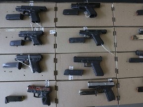 In this file photo taken on Aug. 10, 2022, York Regional Police show off guns and drugs seized during Project Monarch, which was a joint police operation that targeted an alleged cross-border gun and drug smuggling ring.