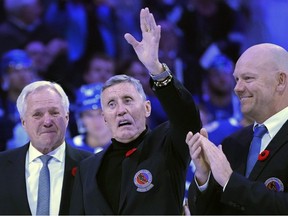 Former Toronto Maple Leafs players and members of the Hockey Hall of Fame, Darryl Sittler, left to right, Borje Salming and Mats Sundin take part in a pregame ceremony prior to NHL hockey action between the Toronto Maple Leafs and Pittsburgh Penguins, in Toronto, Friday, Nov. 11, 2022.