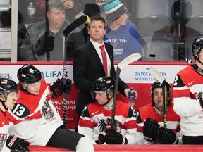 Austria head coach Kirk Furey looks on during the second period of IIHF World Junior Hockey Championship hockey action against Sweden in Halifax on Monday, Dec. 26, 2022.