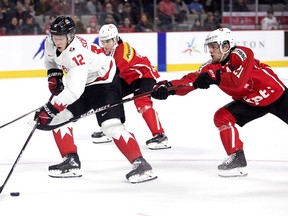 Canada's Reid Schaefer breaks away from Switzerland's Dario Sidler, right, during IIHF World Junior Championship pre-tournament action in Moncton, N.B., on Monday, Dec. 19, 2022.