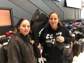 Jamie Anol (left) and Kathryn Fujihara (right) were at the Ottawa International Airport on Tuesday waiting for the arrival of hockey equipment for their children's team, which is visiting from Orange County, California to participate in this week's Bell Capital Cup.