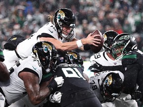 Trevor Lawrence of the Jacksonville Jaguars dives over the goal line for a touchdown against the New York Jets at MetLife Stadium on December 22, 2022 in East Rutherford, New Jersey.