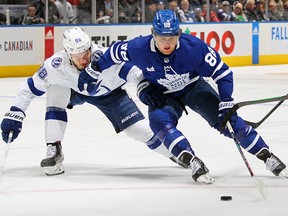 William Nylander of the Toronto Maple Leafs skates around Mikhail Sergachev of the Tampa Bay Lightning at Scotiabank Arena on December 20, 2022 in Toronto.