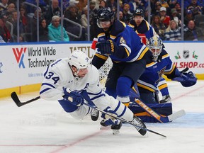Nick Leddy of the St. Louis Blues knocks Maple Leafs' Auston Matthews off the puck during the second period at Enterprise Center on Dec. 27, 2022 in St Louis, Mo.