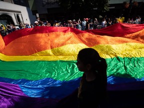 A giant rainbow flag is carried during the Vancouver Pride Parade, in Vancouver, on Sunday, July 31, 2022.