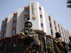 Soldiers stand guard in front of the Radisson Blu hotel prior to the visit of Malian President Ibrahim Boubacar Keita in Bamako, Mali, Nov. 21, 2015.