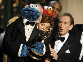 Bob McGrath, right, looks at the Cookie Monster as they accept the Lifetime Achievement Award for '"Sesame Street" at the Daytime Emmy Awards on Aug. 30, 2009, in Los Angeles.