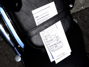 A parking ticket is seen on the seat of a motorcycle on July 3, 2013 in San Francisco, California.