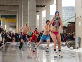 People stripped down and taking part in Polar Bear Skate at The Bentway.
