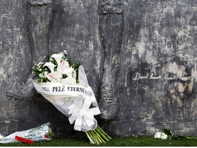 A bouquet of flowers reading "Eternal Pele? is seen with other flowers at the Vila Belmiro stadium as fans of Brazilian soccer legend Pele mourn his death, in Santos, Brazil, December 30, 2022.